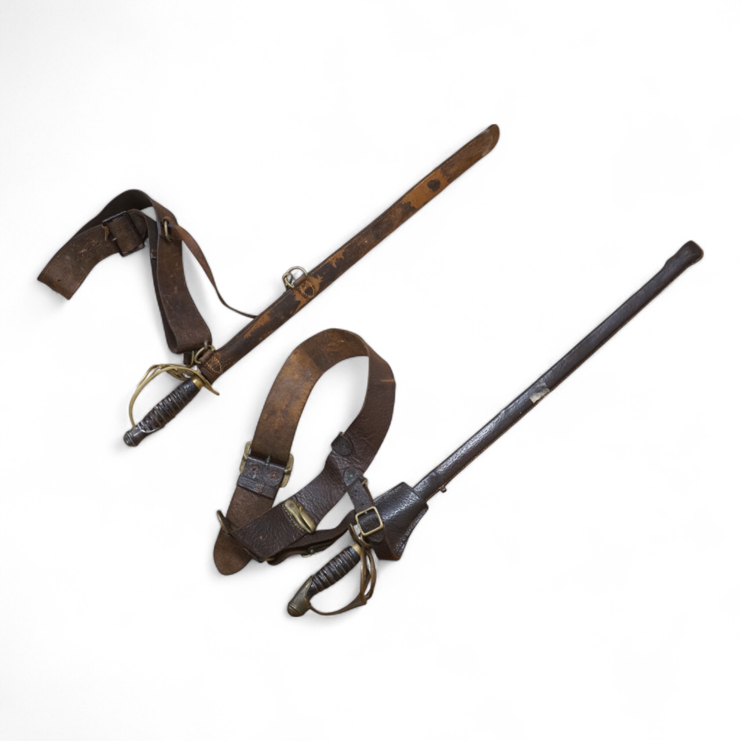 Two early 20th century Imperial German child’s swords with leather scabbards and hangers, blades 45.5cm
